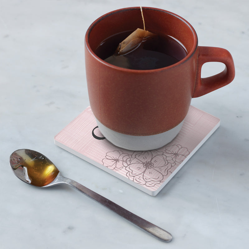 Cup of tea sitting on coaster in kitchen